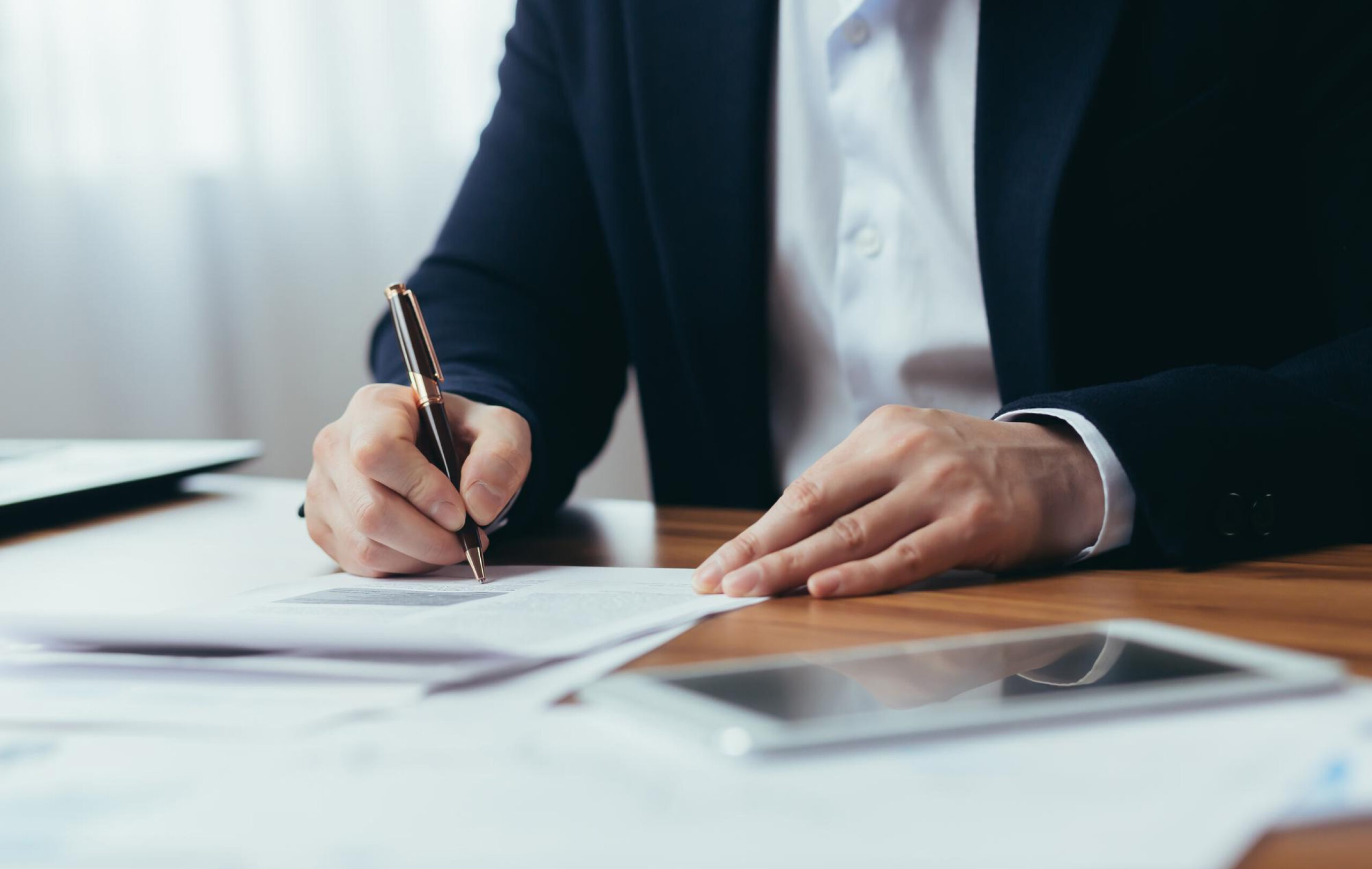 man signs a letter
